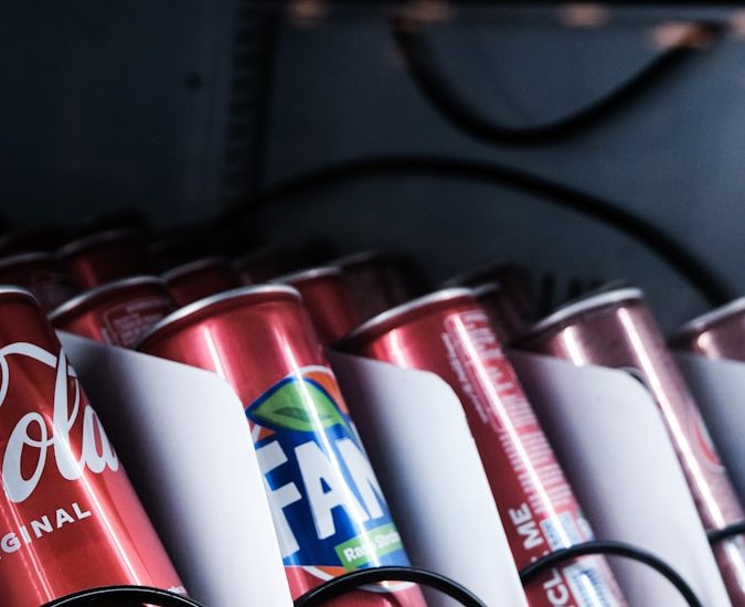 a row of red and white cups on a shelf